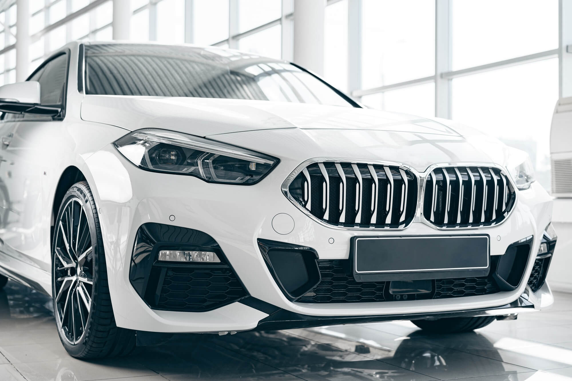 white-luxury-passenger-car-standing-inside-salon.jpg